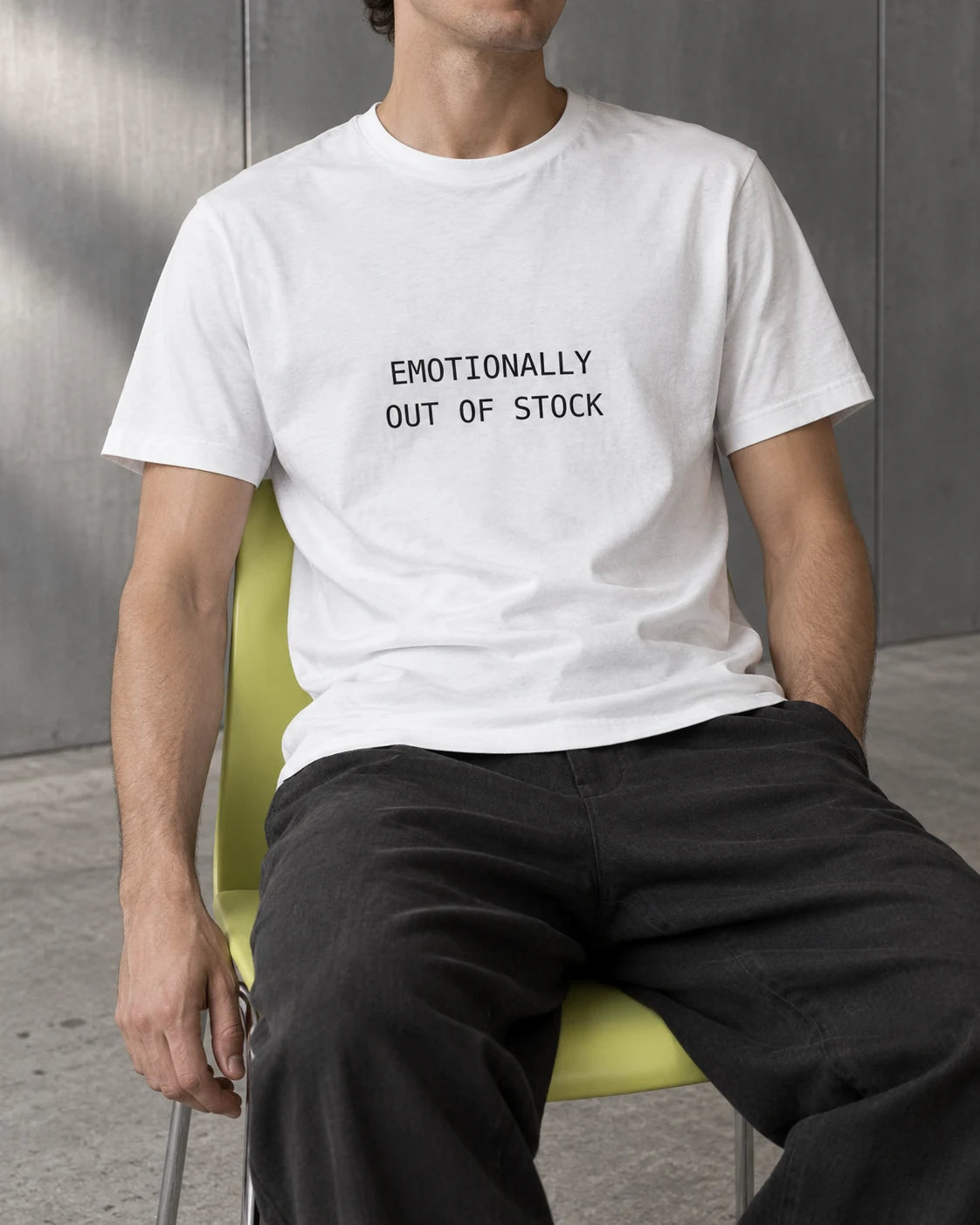 Campaign image of a model wearing the white Emotionally Out of Stock T-shirt.